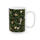 A ceramic mug with a black background featuring a floral William Morris & Co pattern of birds and pomegranates.