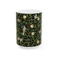 A ceramic mug with a black background featuring a floral William Morris & Co pattern of birds and pomegranates.