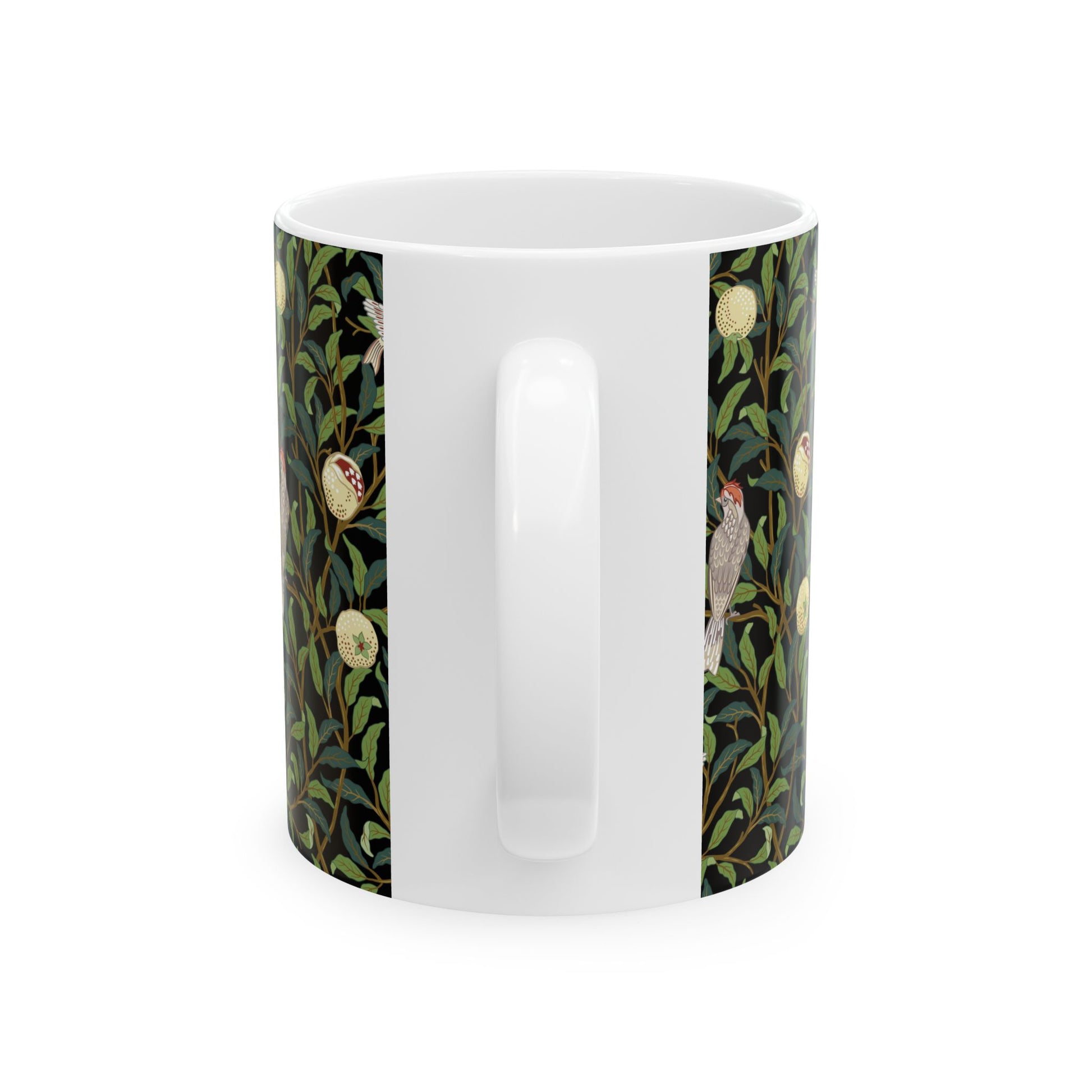 A ceramic mug with a black background featuring a floral William Morris & Co pattern of birds and pomegranates.