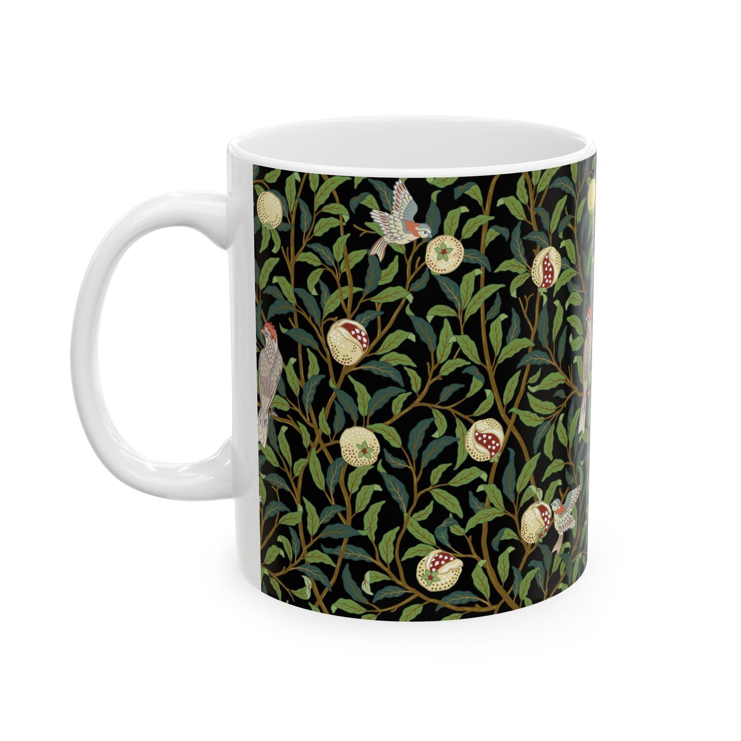 A ceramic mug with a black background featuring a floral William Morris & Co pattern of birds and pomegranates.