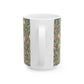 A white ceramic mug with a pink floral and pomegranate design inspired by William Morris.