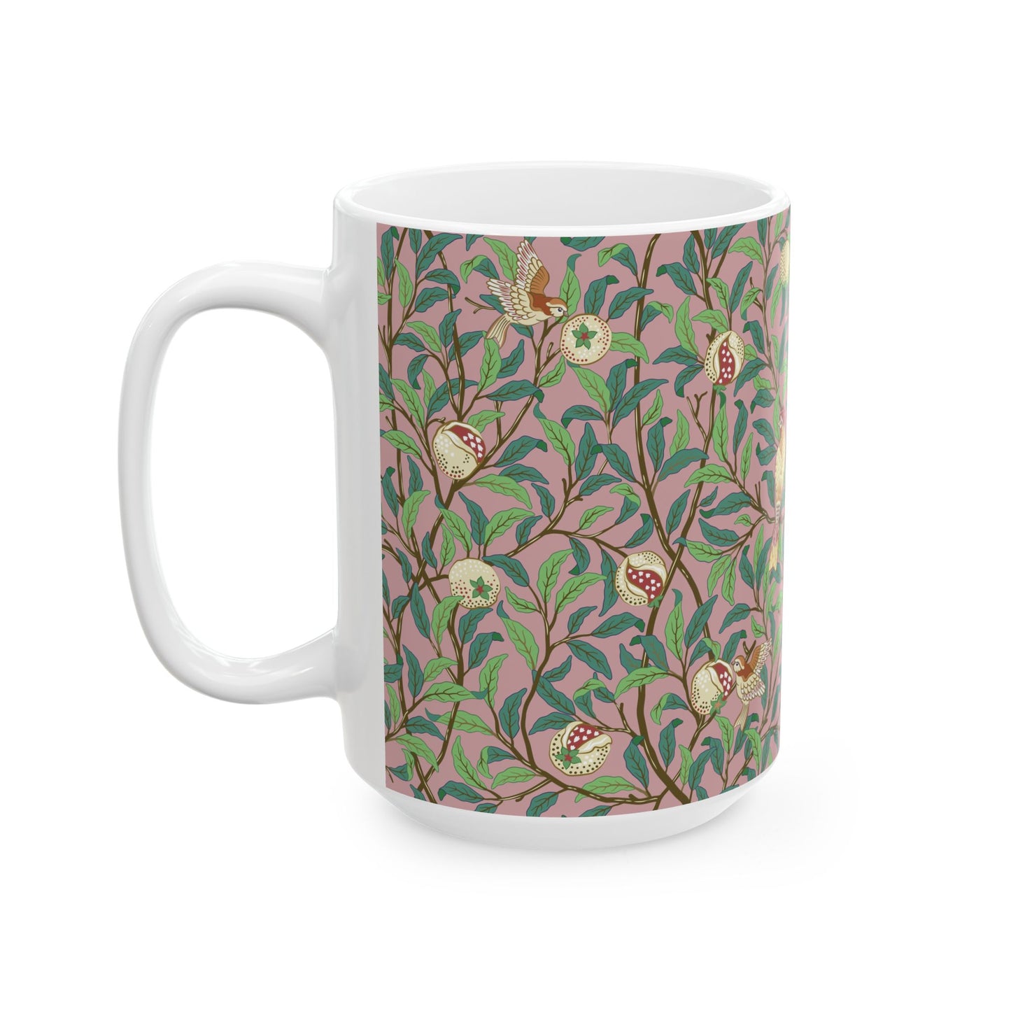 A white ceramic mug with a pink floral and pomegranate design inspired by William Morris.