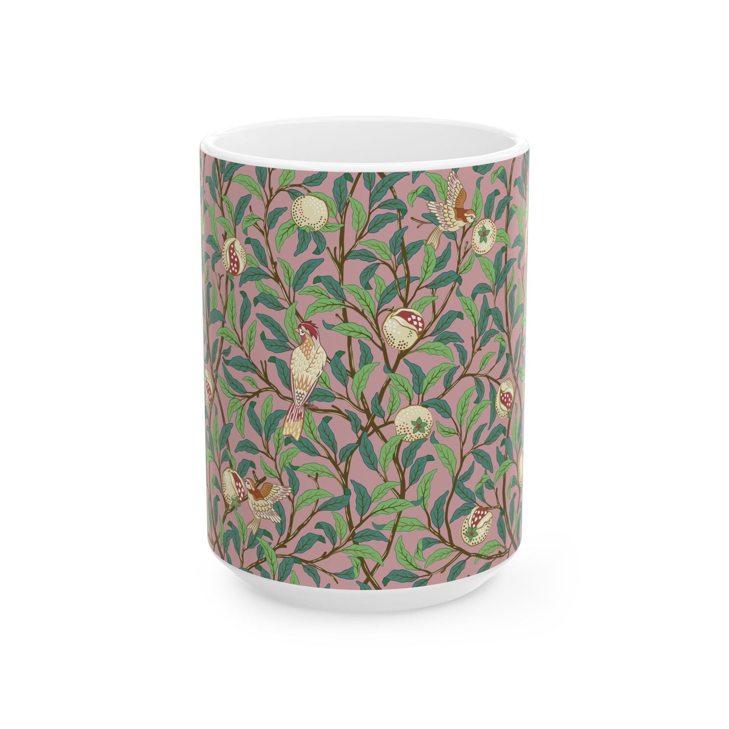 A white ceramic mug with a pink floral and pomegranate design inspired by William Morris.