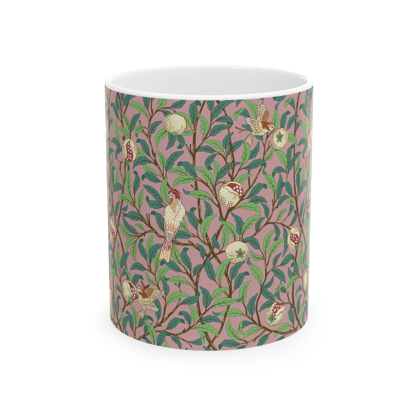 A white ceramic mug with a pink floral and pomegranate design inspired by William Morris.