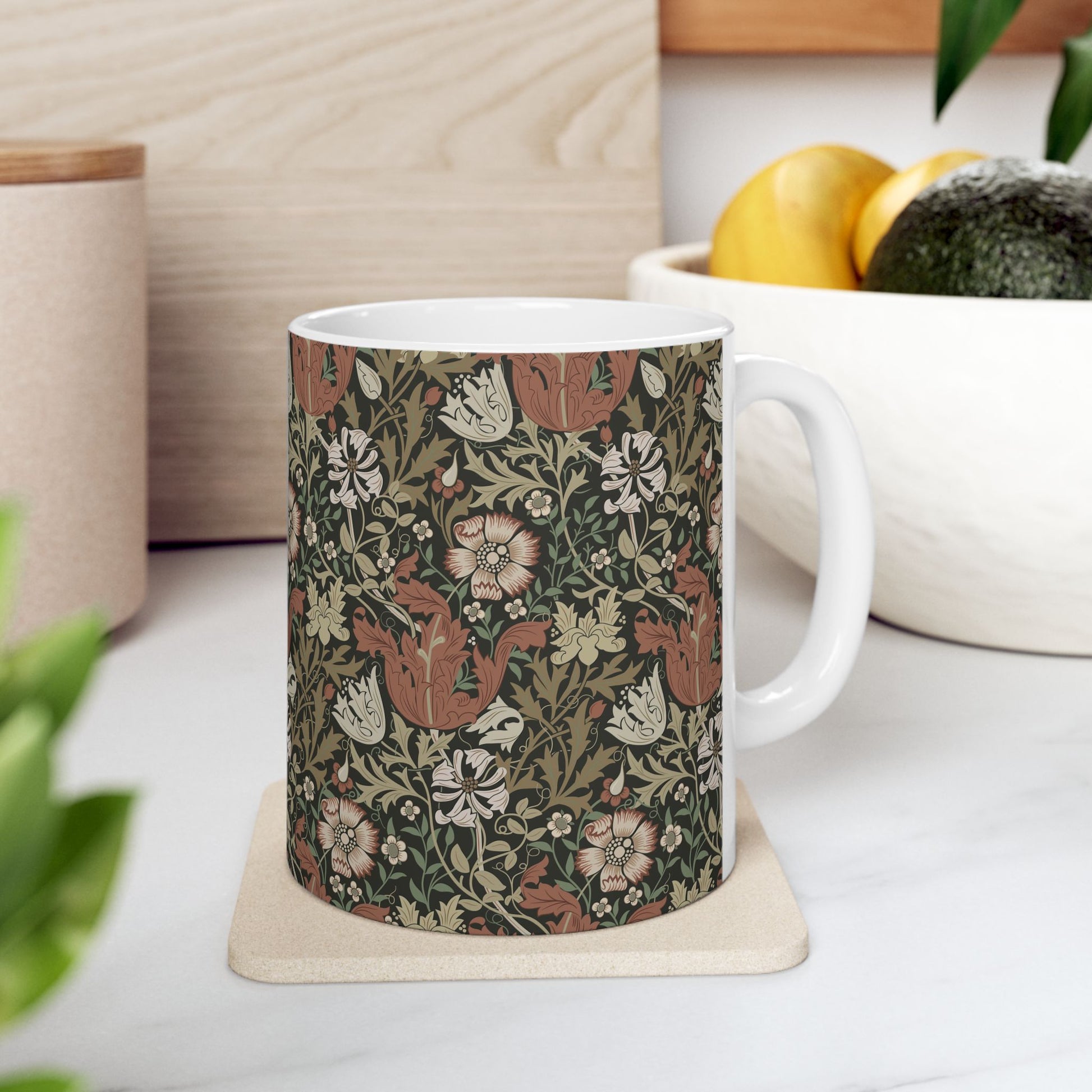 A white ceramic mug with a floral Arts & Crafts pattern called Compton which was inspired by William Morris & Co