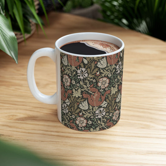 A white ceramic mug with a floral Arts & Crafts pattern called Compton which was inspired by William Morris & Co