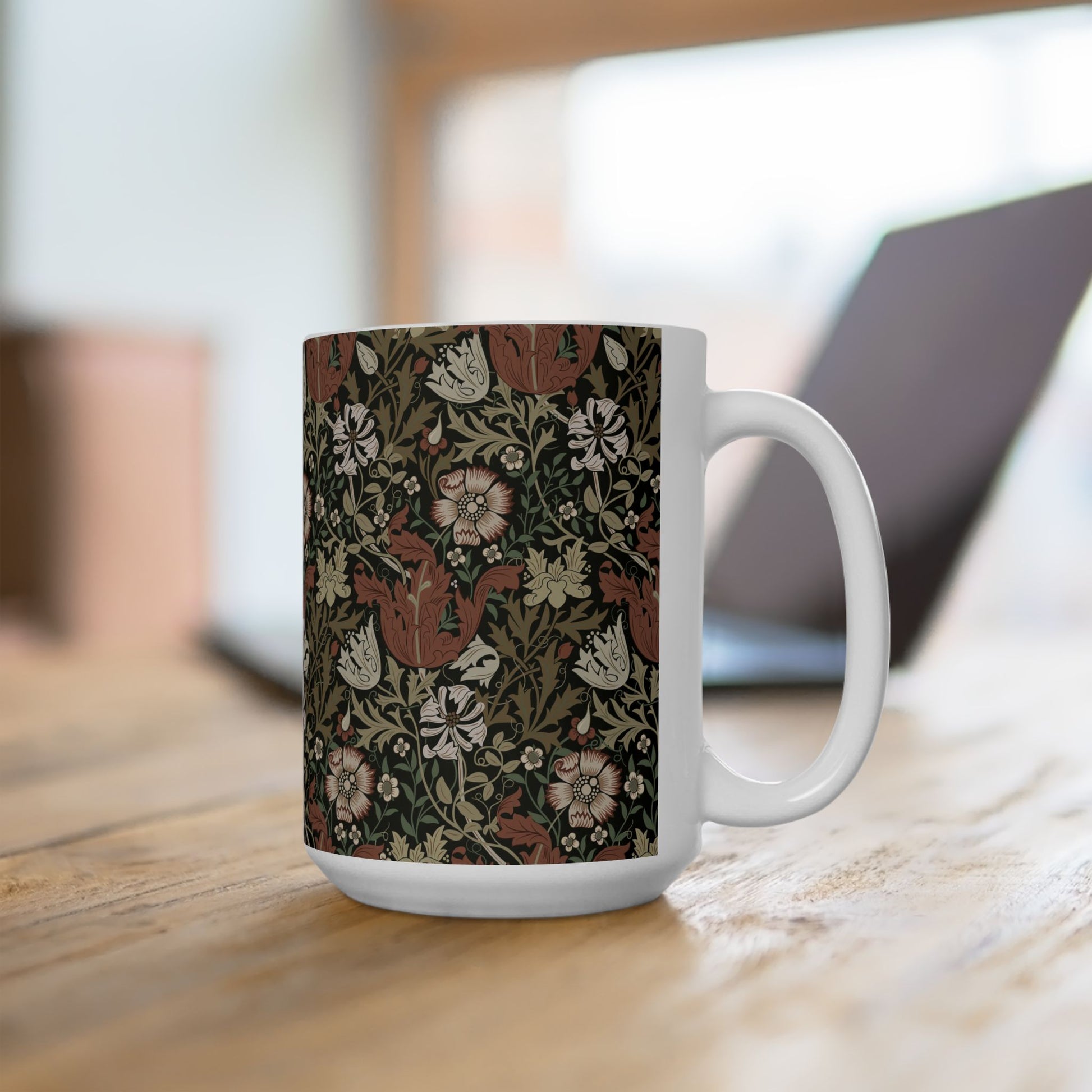 A white ceramic mug with a floral Arts & Crafts pattern called Compton which was inspired by William Morris & Co