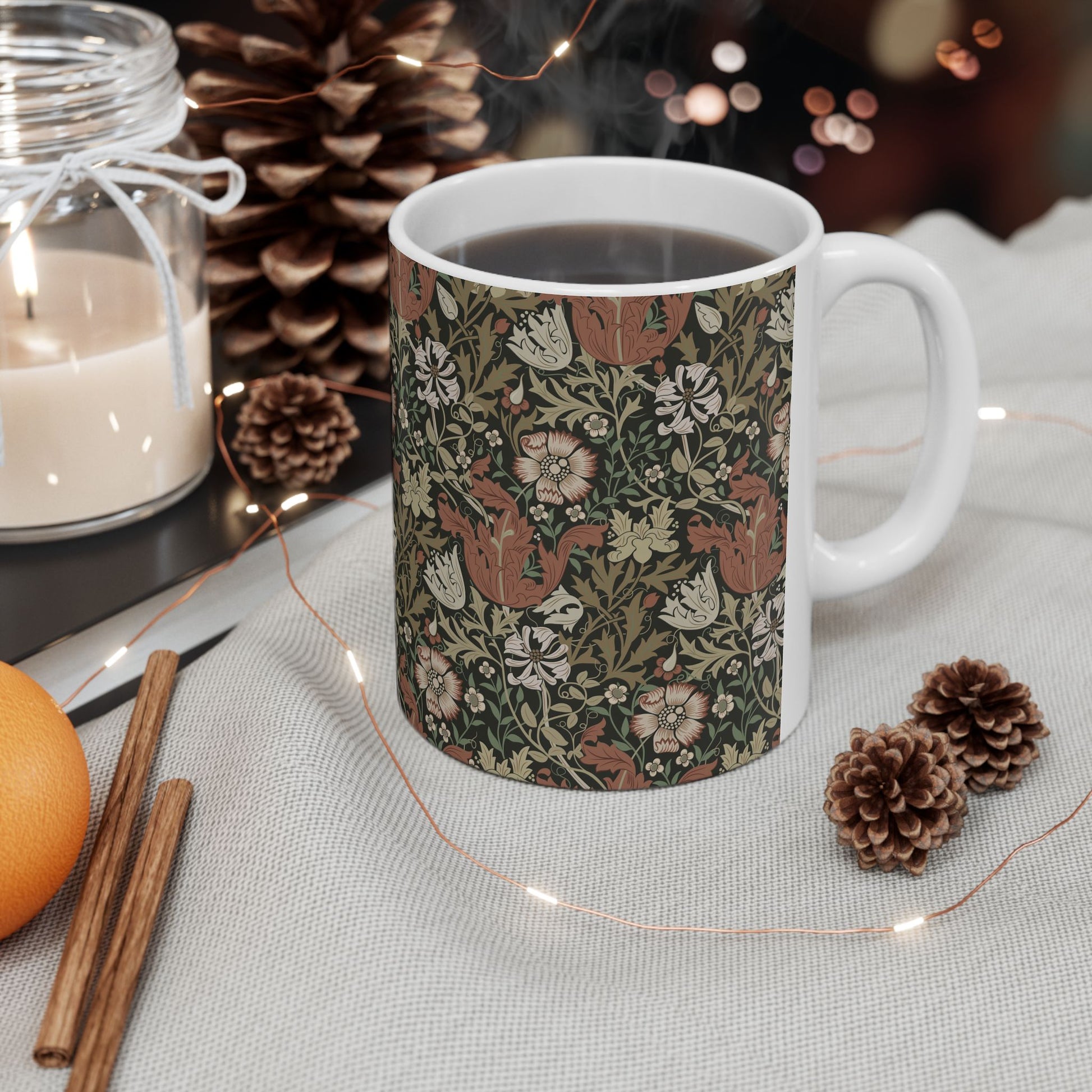A white ceramic mug with a floral Arts & Crafts pattern called Compton which was inspired by William Morris & Co