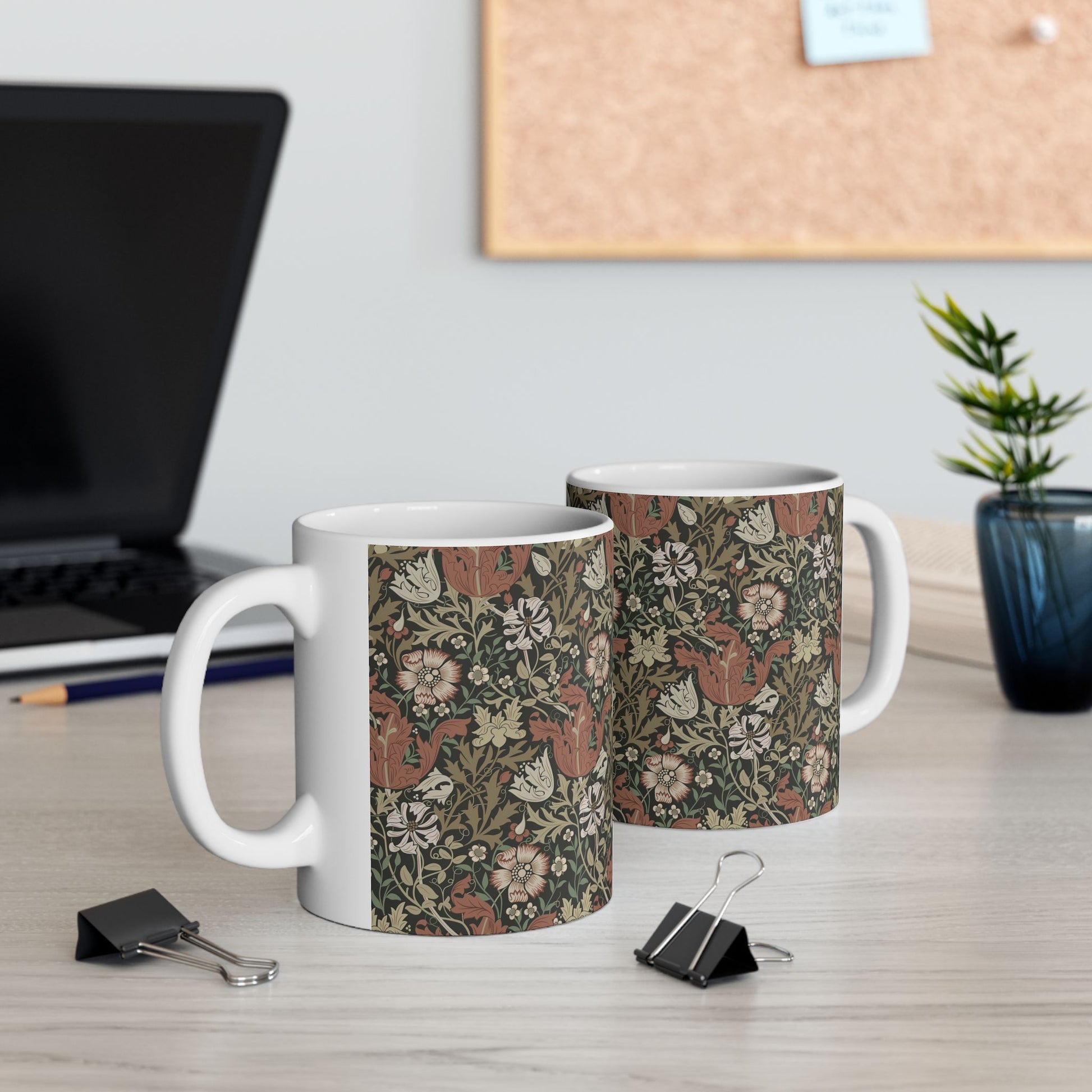 A white ceramic mug with a floral Arts & Crafts pattern called Compton which was inspired by William Morris & Co