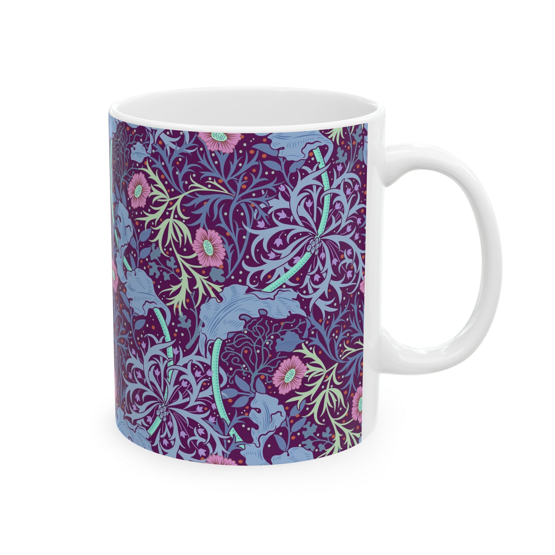 A white ceramic mug with a pink floral seaweed pattern inspired by William Morris.