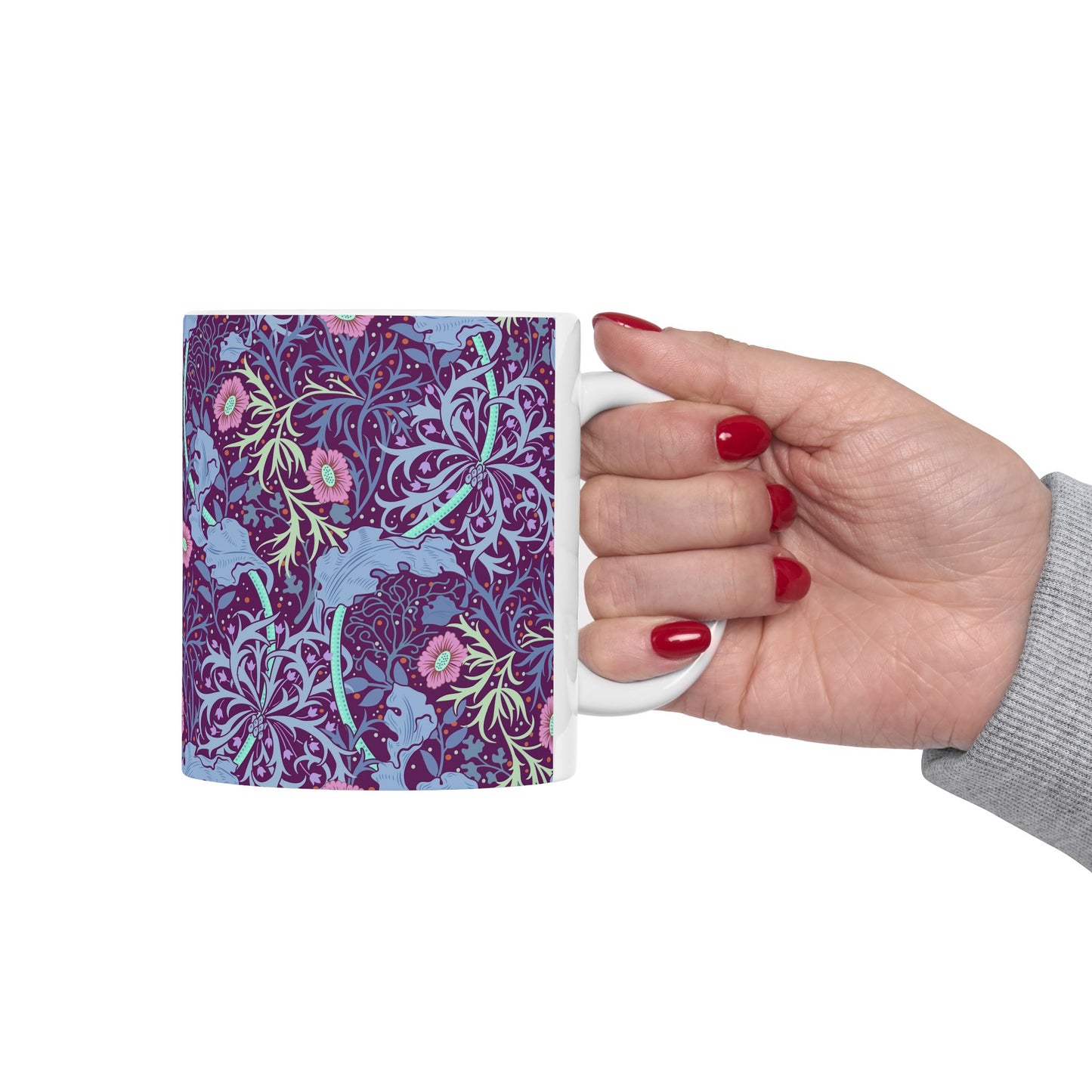 A white ceramic mug with a pink floral seaweed pattern inspired by William Morris.