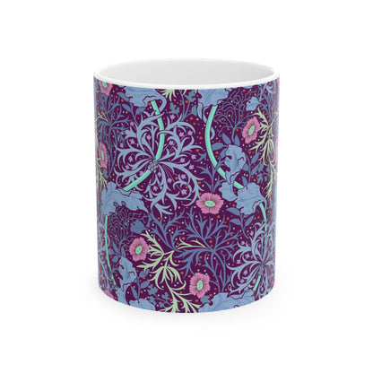 A white ceramic mug with a pink floral pattern inspired by William Morris.