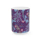 A white ceramic mug with a pink floral pattern inspired by William Morris.