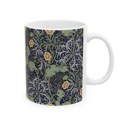 A white ceramic mug with a yellow and green floral pattern from the Collection called Seaweed inspired by William Morris.