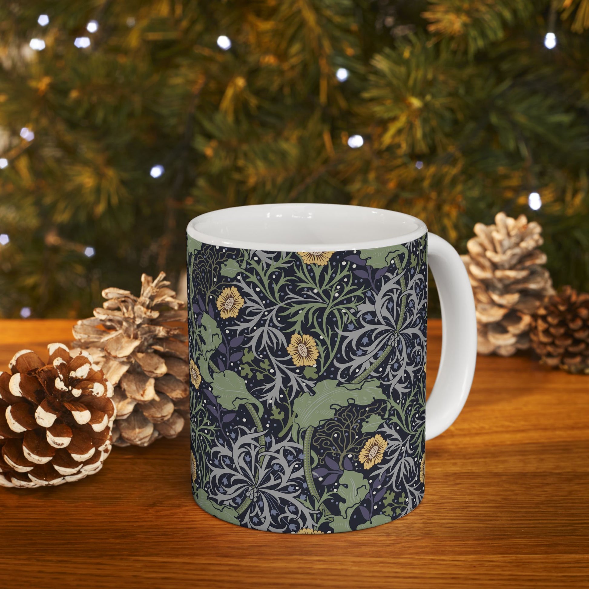 A white ceramic mug with a yellow and green floral pattern from the Collection called Seaweed inspired by William Morris.