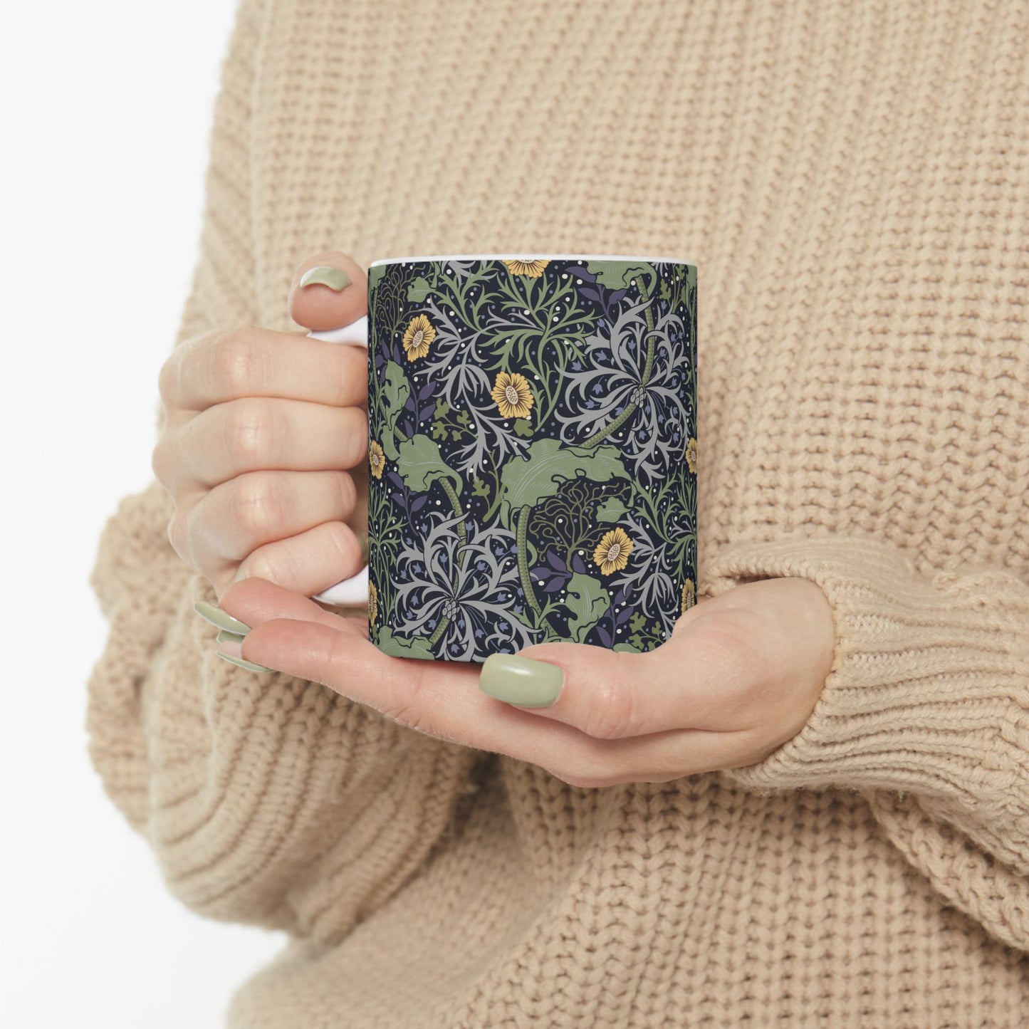 A white ceramic mug with a yellow and green floral pattern from the Collection called Seaweed inspired by William Morris.