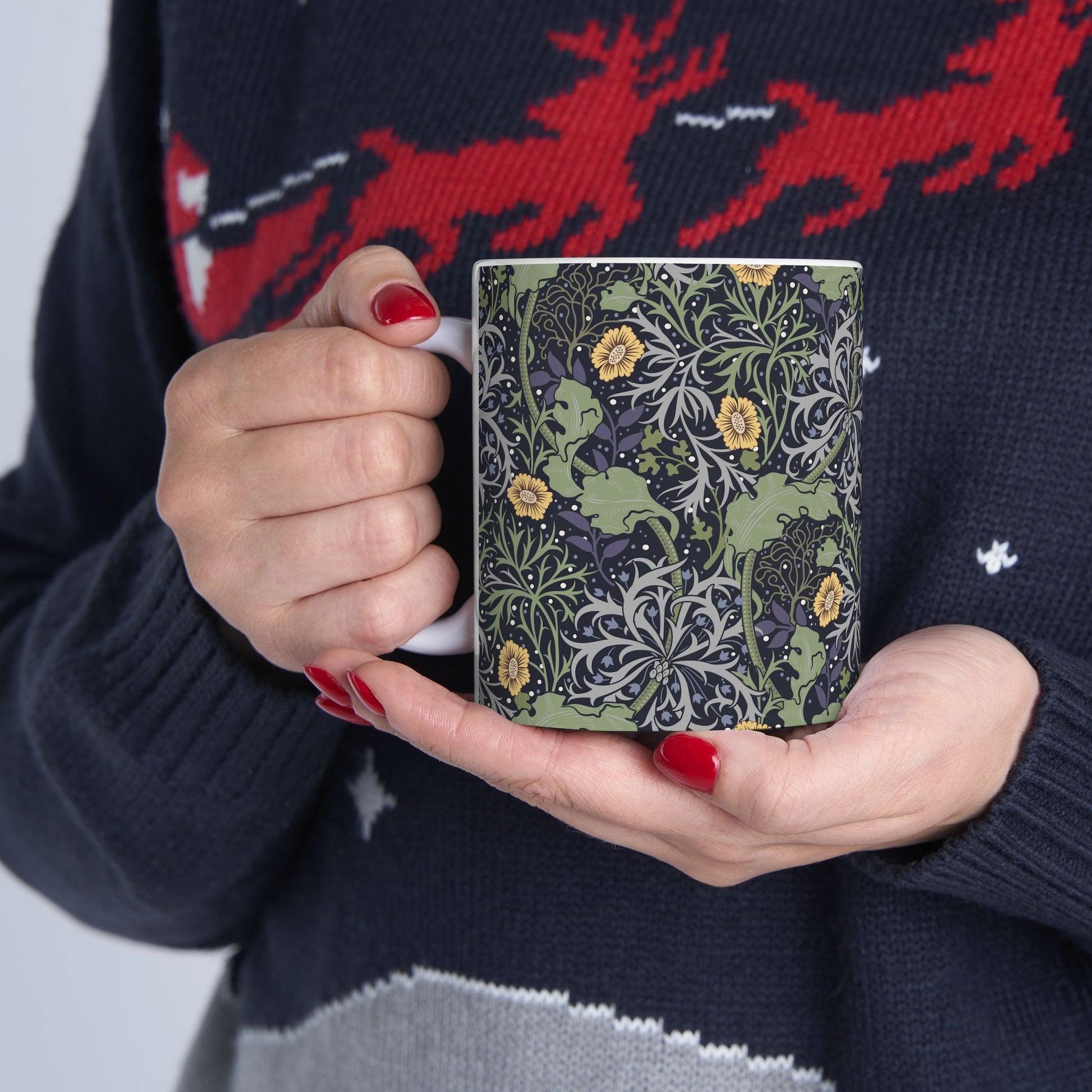 A white ceramic mug with a yellow and green floral pattern from the Collection called Seaweed inspired by William Morris.