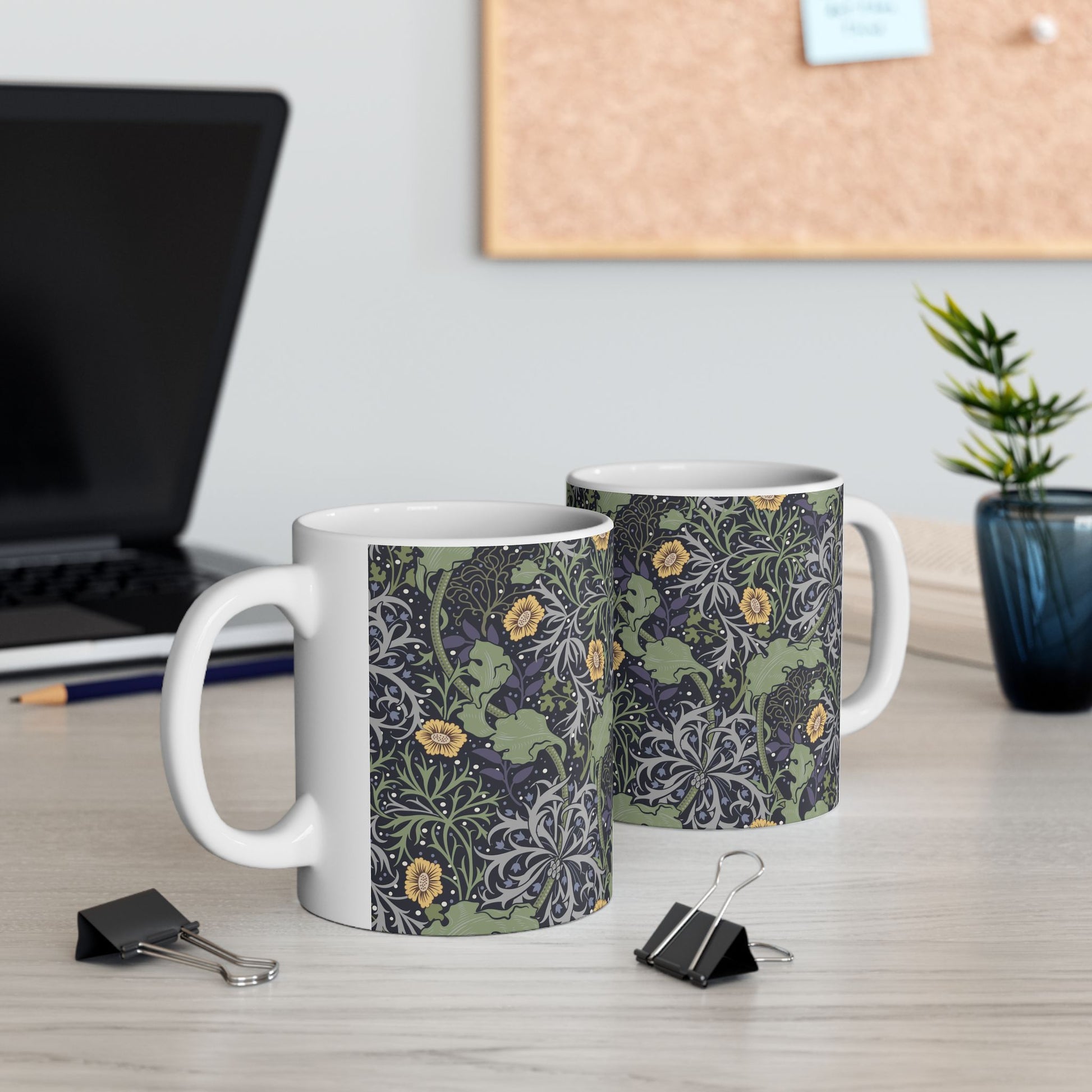 A white ceramic mug with a yellow and green floral pattern from the Collection called Seaweed inspired by William Morris.