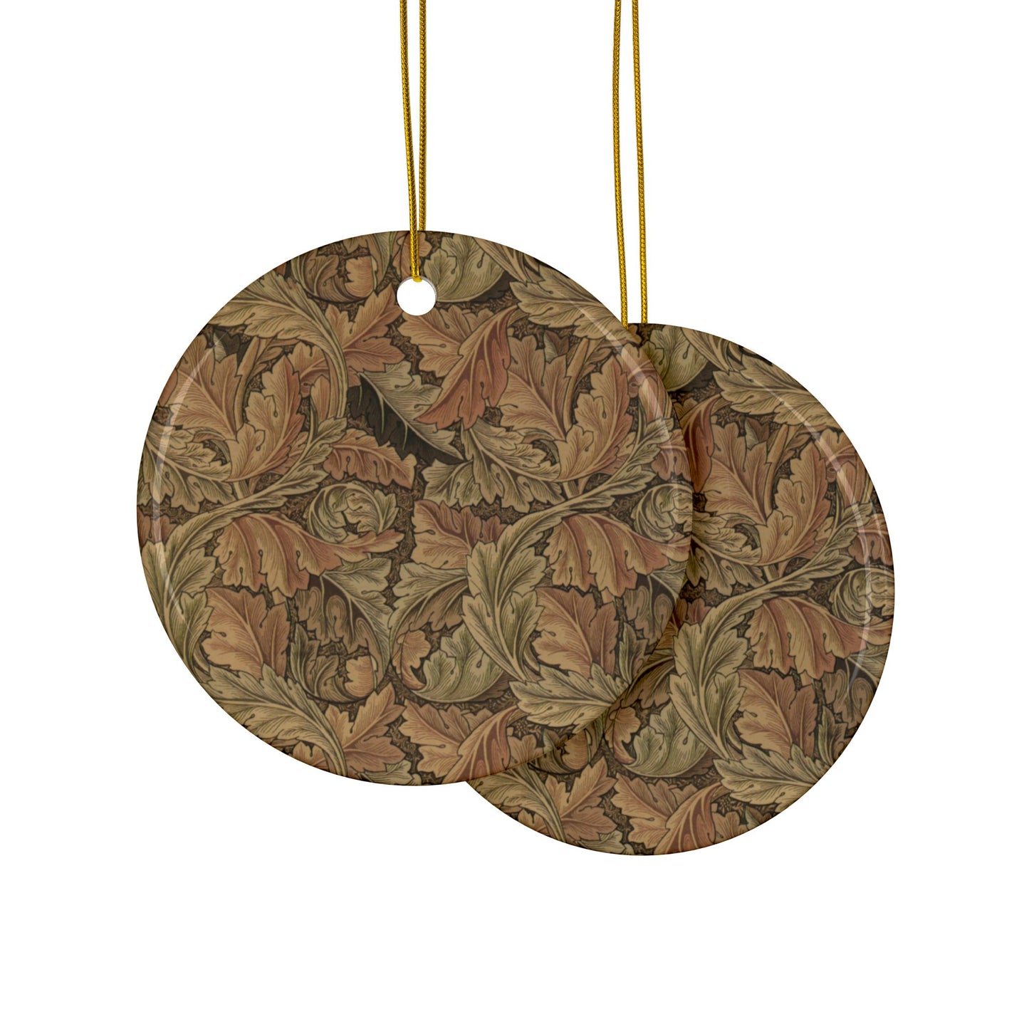 Two round decorative items with leaf pattern and gold strings on a white background