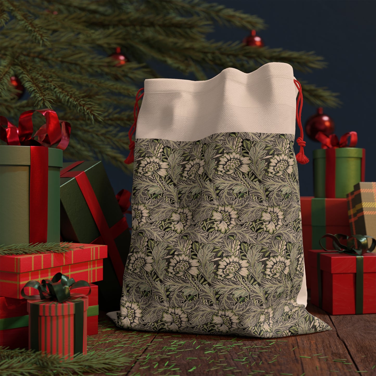 A rectangular Christmas-themed linen drawstring bag with a floral William Morris & Co pattern in gray, beige, and red colours, featuring a red drawstring at the top.