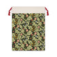 A beige linen drawstring gift bag with a vintage floral pattern inspired by William Morris design, featuring a red drawstring at the top.