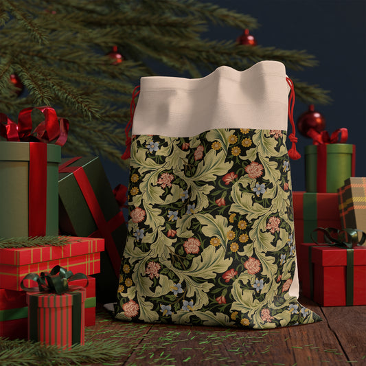 A beige linen drawstring gift bag with a vintage floral pattern inspired by William Morris design, featuring a red drawstring at the top.