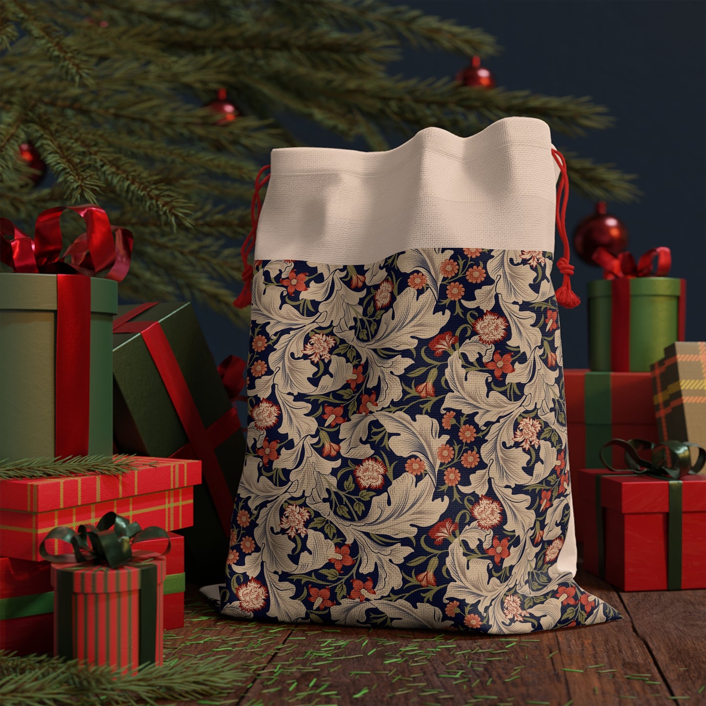 A rectangular Christmas-themed linen drawstring bag with a floral pattern, primarily in red and green colours, and a red drawstring at the top.