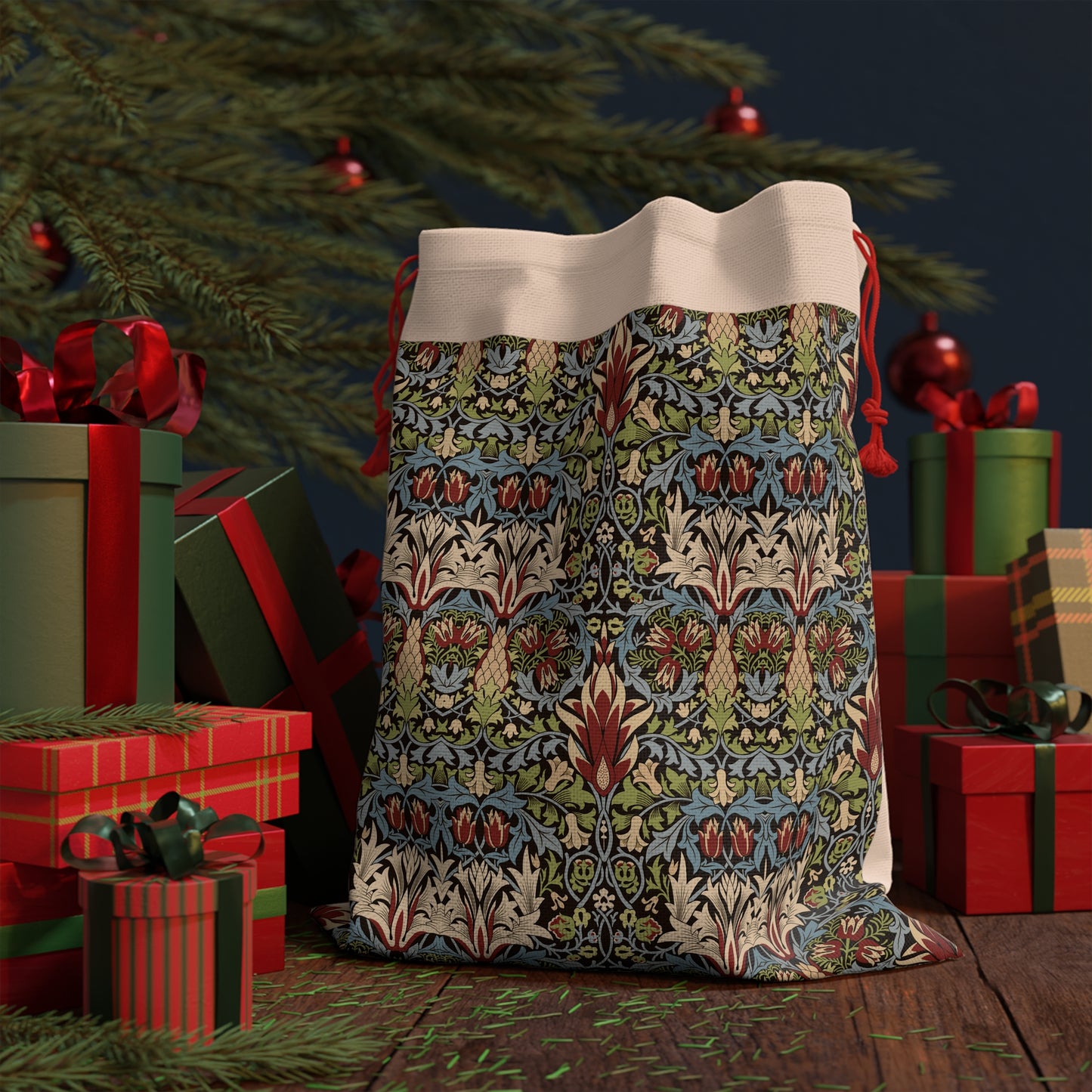 A beige linen gift bag with a floral pattern inspired by William Morris designs, featuring a red drawstring at the top.