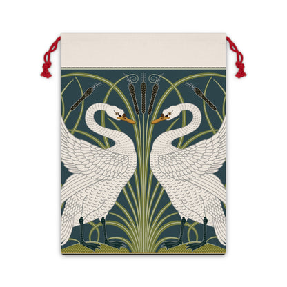 A Christmas-themed linen drawstring bag with a vintage William Morris & Co design featuring white swans on a green and blue background, finished with red drawstrings.
