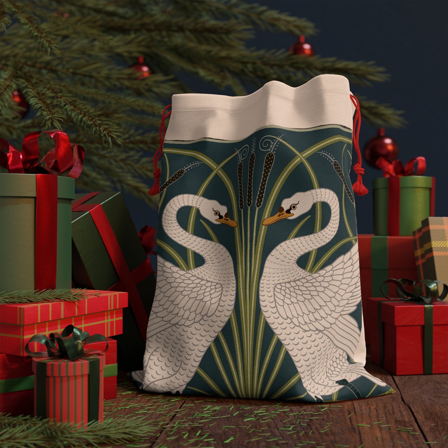 A Christmas-themed linen drawstring bag with a vintage William Morris & Co design featuring white swans on a green and blue background, finished with red drawstrings.