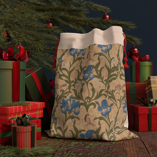 Decorative gift bag with floral pattern in front of Christmas presents and tree.