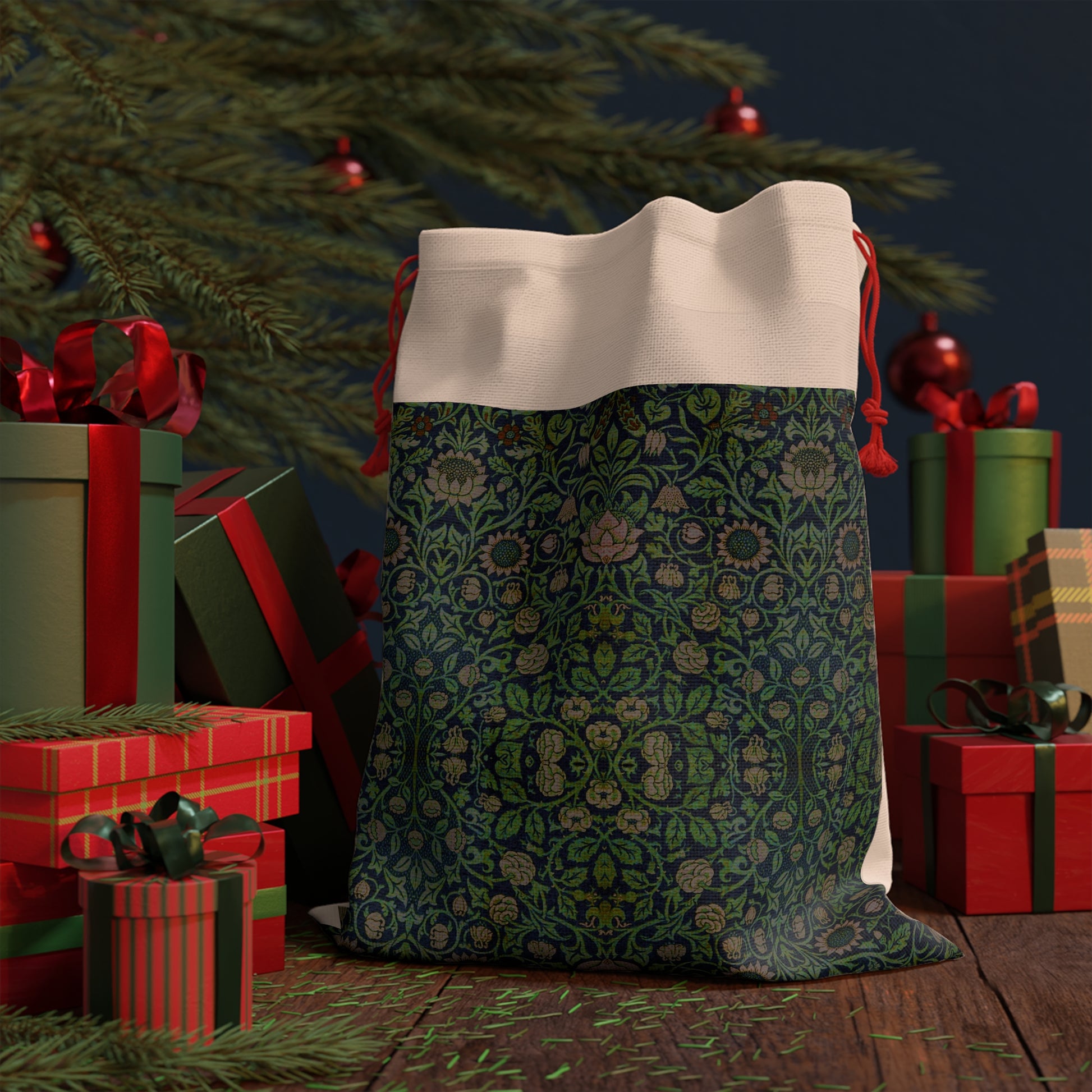 A green Christmas gift bag with a floral pattern inspired by the William Morris Violet and Columbine Collection, featuring a red drawstring.