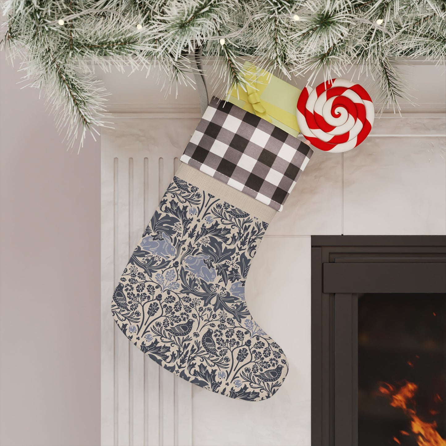 Decorative Christmas stocking hanging by a fireplace with a lollipop ornament.