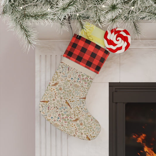 Decorative Christmas stocking with a red and black checkered top hanging by a fireplace.