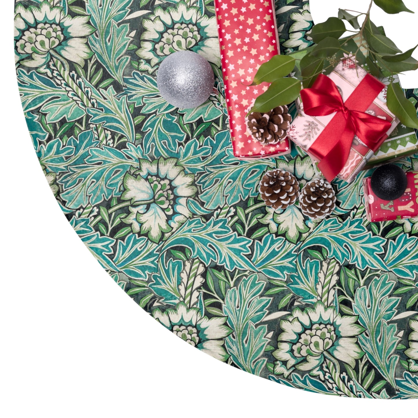 Decorative green leaf-patterned tree skirt with Christmas decorations on a white background