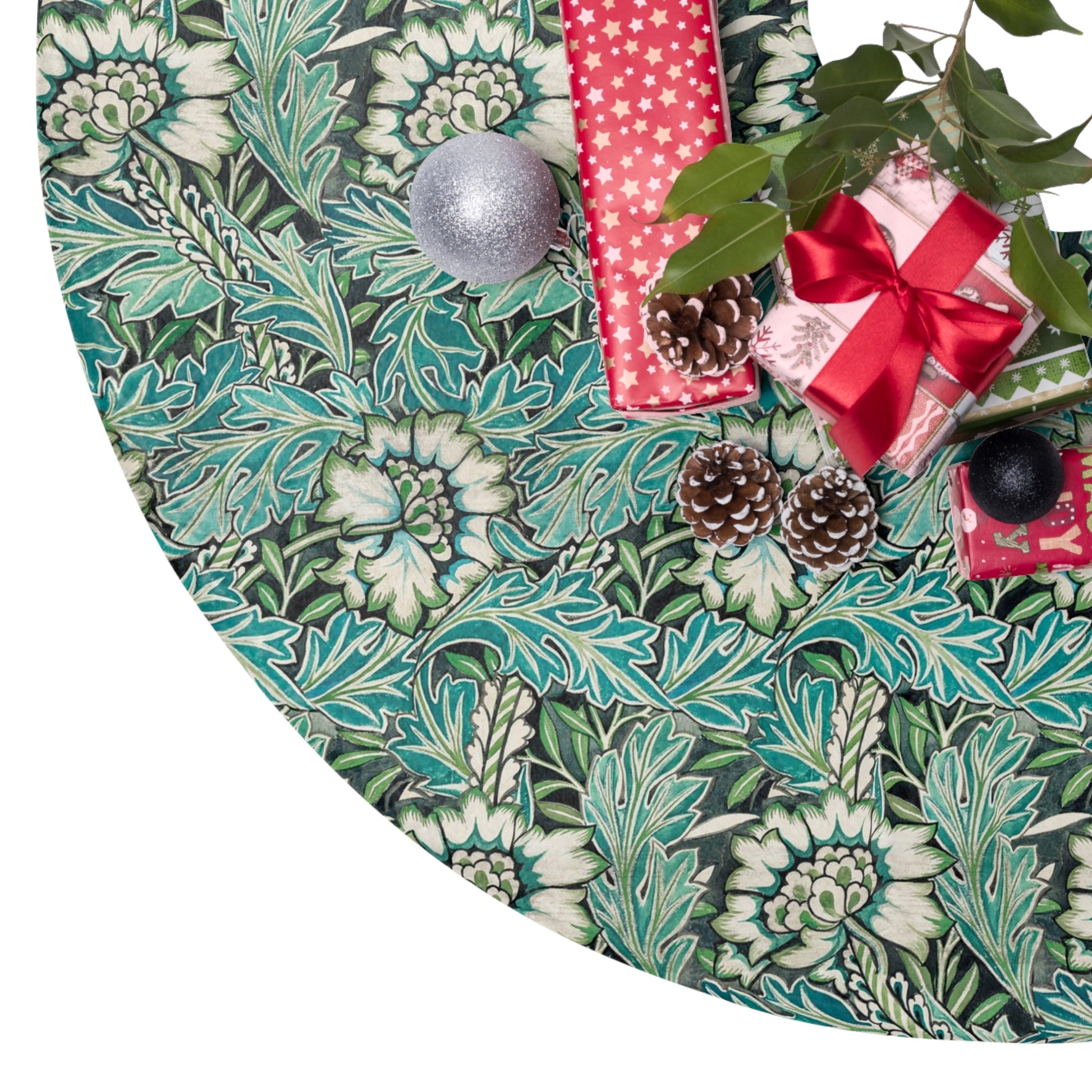 Decorative green leaf-patterned tree skirt with Christmas decorations on a white background