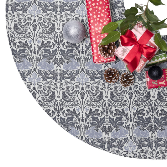 Decorative Christmas tree skirt with a gray and white pattern, surrounded by Christmas decorations.