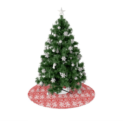 Decorated Christmas tree with a red and white patterned base on a white background