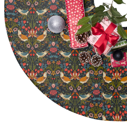 Decorative Christmas tree skirt with floral and bird pattern, surrounded by gift boxes and pinecones.