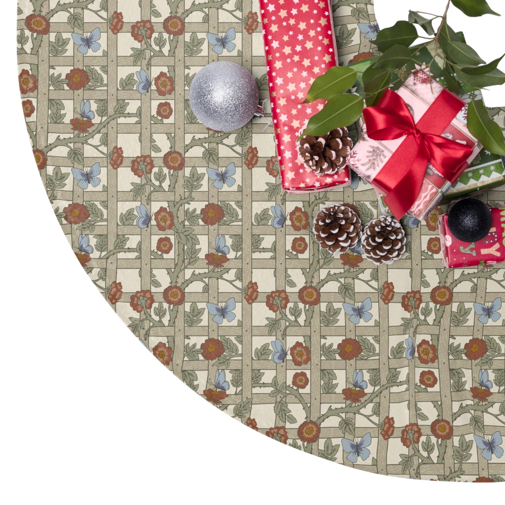 Decorative Christmas tree skirt with floral and butterfly pattern, surrounded by Christmas presents and decorations.