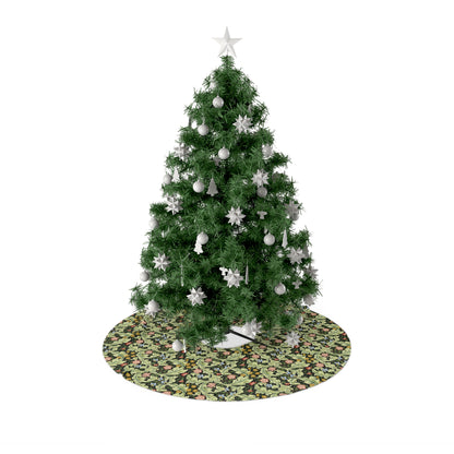 A green Christmas tree skirt with a floral pattern, placed under a artificial Christmas tree with a star at the top.