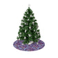 A Christmas tree skirt with a pink floral pattern based on the William Morris Seaweed Collection, displayed around the base of a Christmas tree.