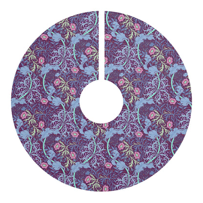 A Christmas tree skirt with a pink floral pattern based on the William Morris Seaweed Collection, displayed around the base of a Christmas tree.