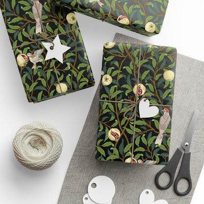Gift boxes wrapped in decorative paper with birds and branches, surrounded by scissors and yarn.