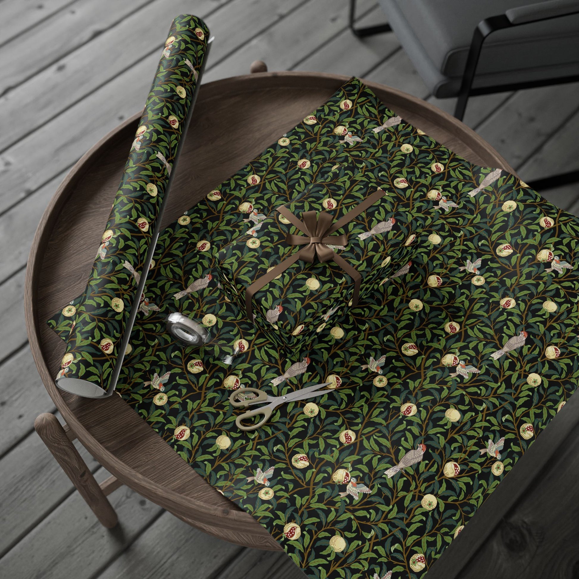 Decorative green wrapping paper with floral patterns on a wooden tray.