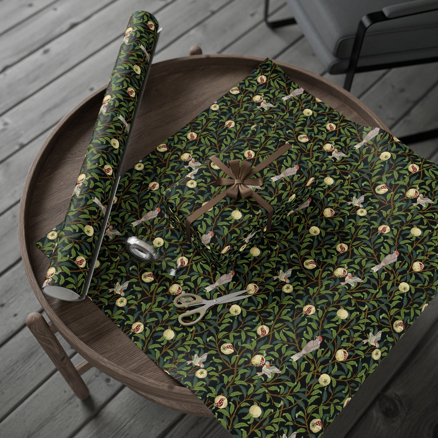 Decorative green wrapping paper with floral patterns on a wooden tray.