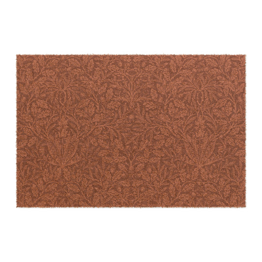 A rectangular coconut coir doormat with an intricate floral William Morris & Co pattern in a rust colour, mainly for outdoor use.