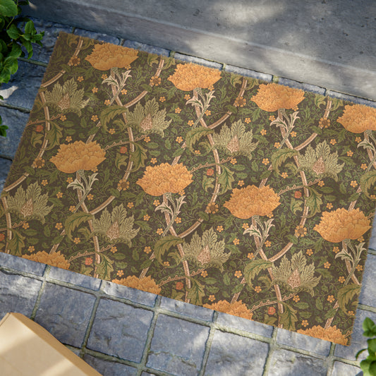A rectangular coconut coir doormat with an intricate floral pattern inspired by William Morris, featuring a mix of green, brown, and yellow colours.