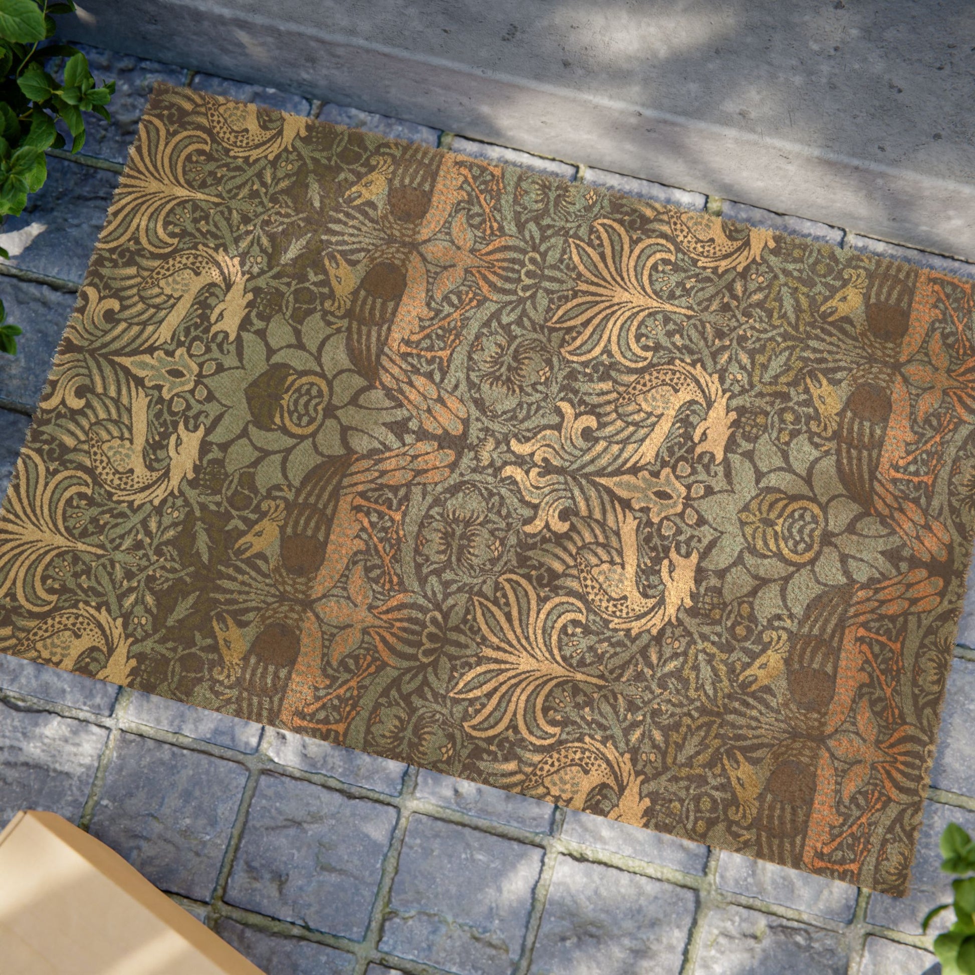 Decorative doormat with intricate patterns on a stone pavement