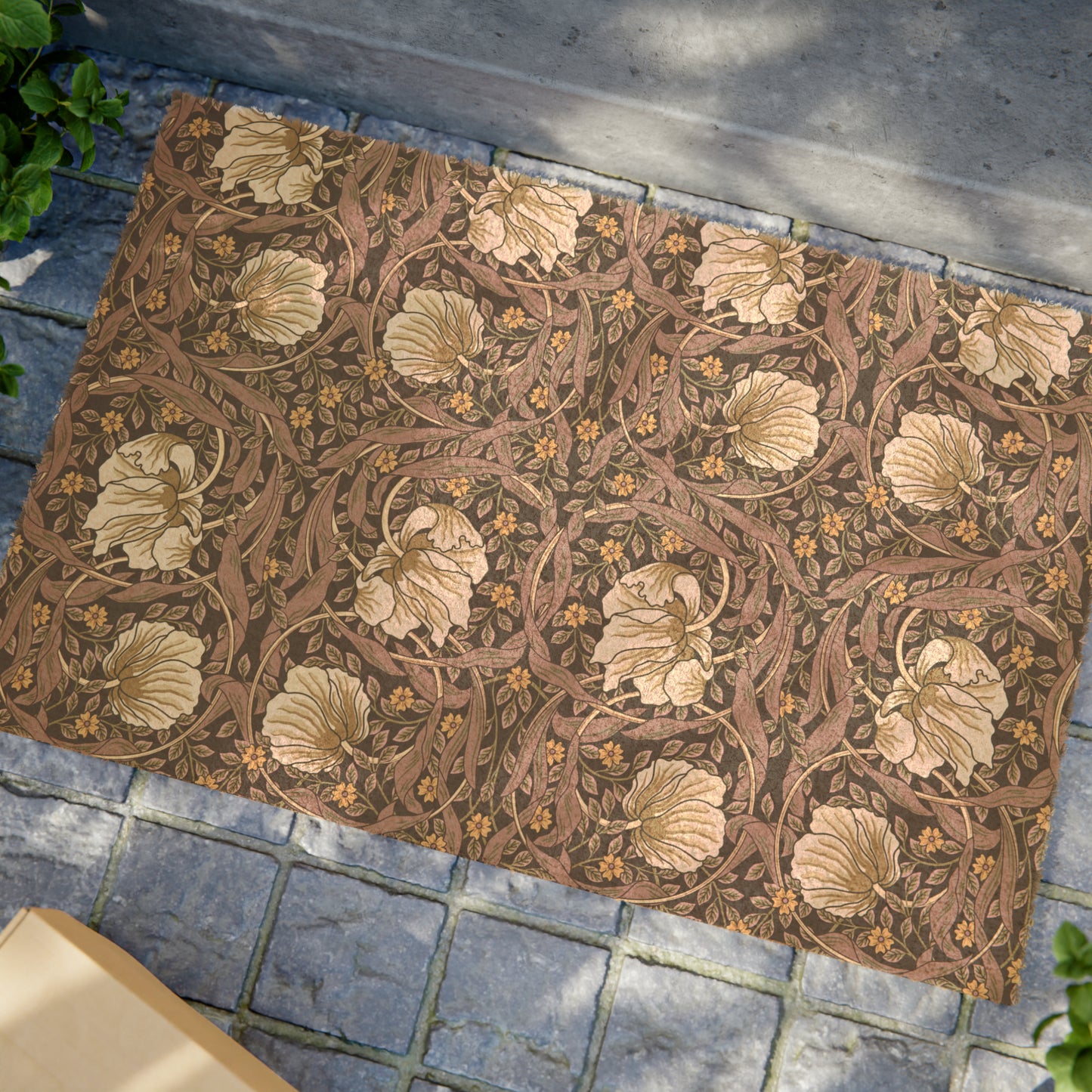 A rectangular coconut coir doormat with an intricate floral William Morris & Co pattern in a rosewood colour, featuring a black vinyl backing.